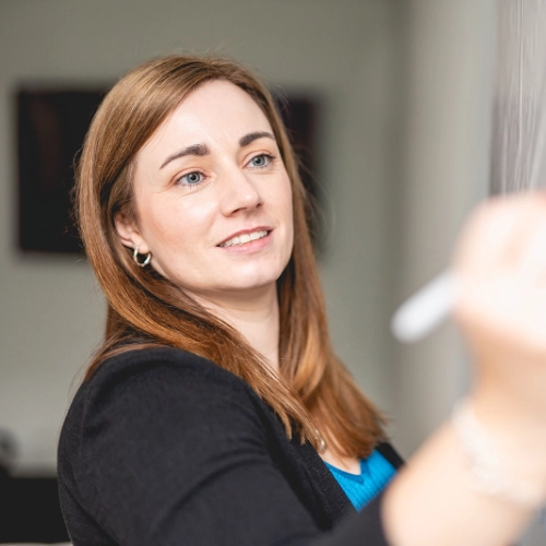 Annie Browne writing on a whiteboard